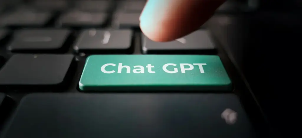 Finger pressing ChatGPT key symbolizing advanced AI features.