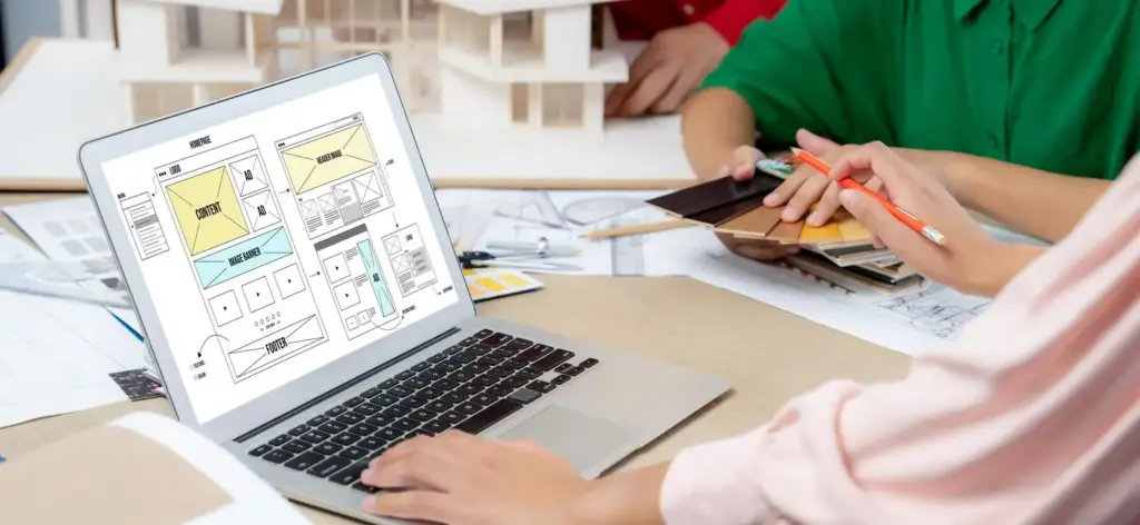 Team reviewing wireframes and system plans during application development process planning.