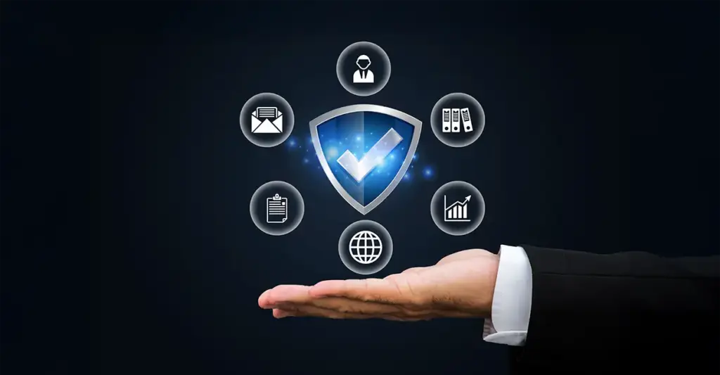 Hand holding shield icon with connected symbols for software security, compliance, and data control.