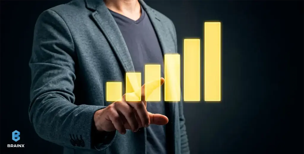Business leader pointing at rising bar chart to represent scaling offshore development operations.